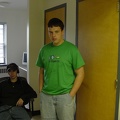 Carver standing, Aaron sitting in hall.
