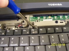 Remove the screws from the top of the keyboard.